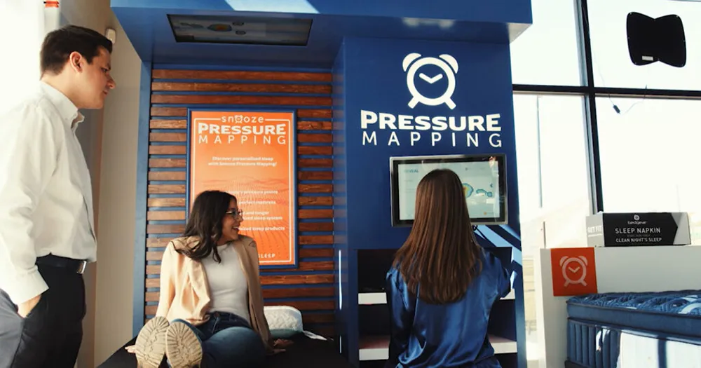 Customers at the Pressure Mapping station inside Snooze Mattress Company Brownsville